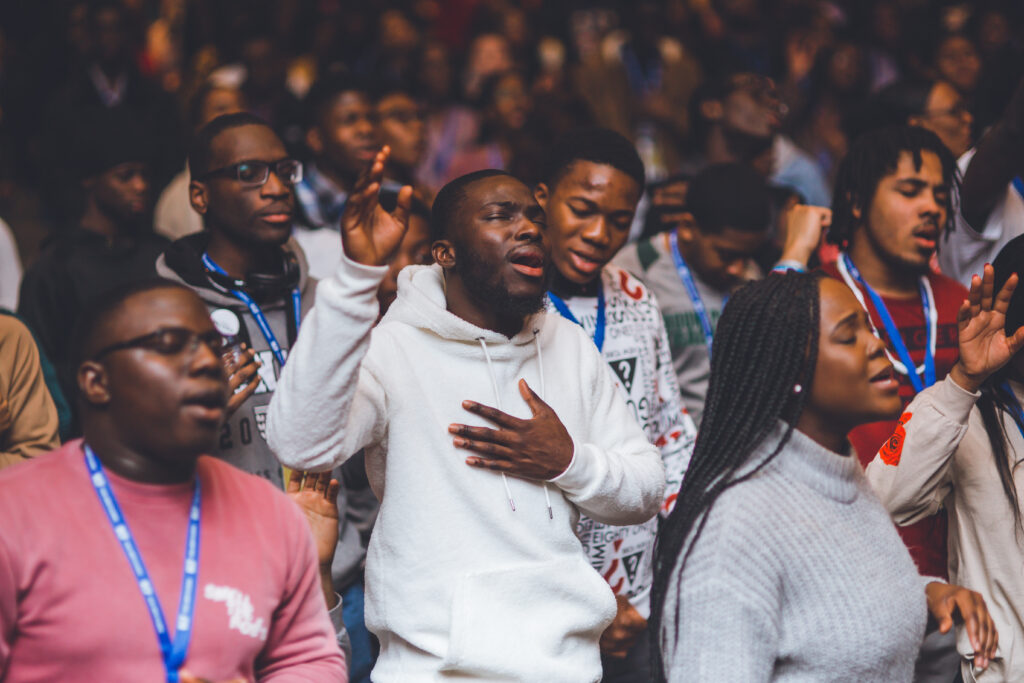 Group of people worshipping with hands lifted